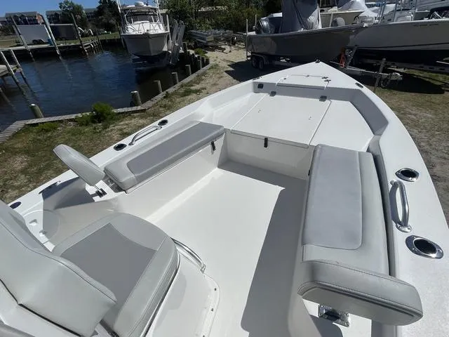 Slide: The Image of 2025 Bay Rider 239 Bay boat with spacious seating, docked near water. - 8