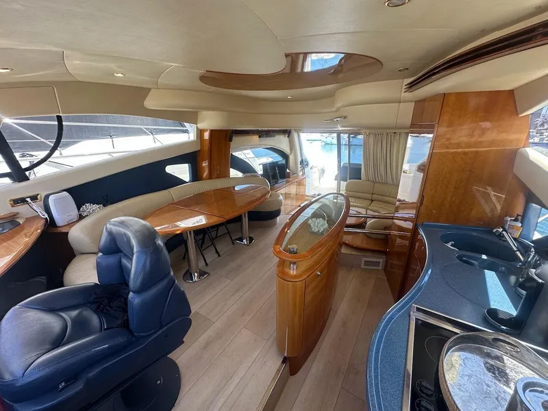 Slide: The Image of Luxurious interior of a 2006 Azimut 55E yacht with elegant wood finishes and modern amenities. - 10
