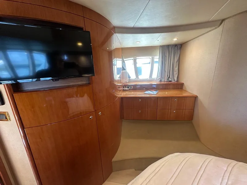 Slide: The Image of Luxurious interior of 2006 Azimut 55E yacht with wood paneling and TV. - 16