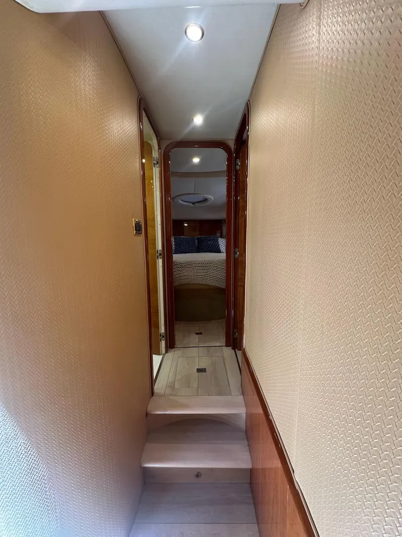 Slide: The Image of Interior hallway of 2006 Azimut 55E yacht with beige walls and wooden accents. - 18