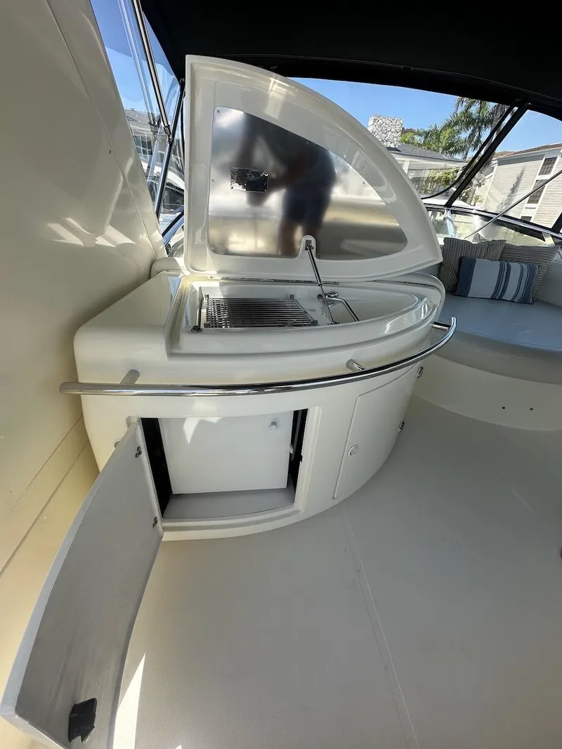 Slide: The Image of Outdoor kitchen area on a 2006 Azimut 55E yacht with grill and storage. - 30