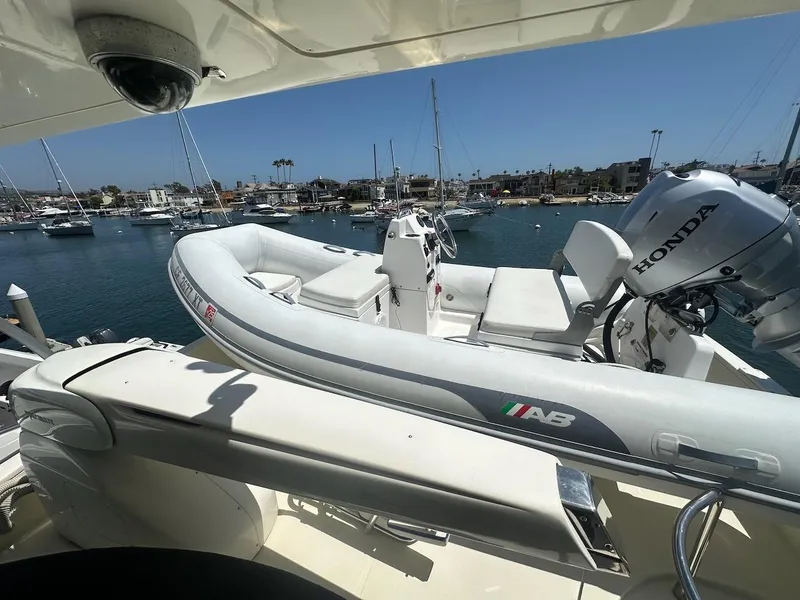 Slide: The Image of Azimut 55E yacht with inflatable boat and Honda motor, docked in a marina, 2006 model. - 34