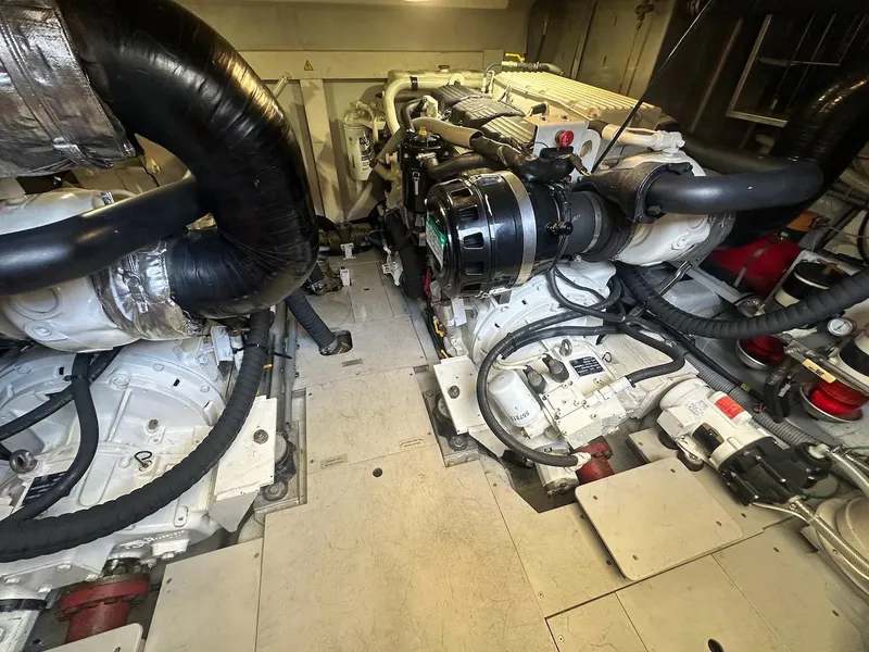 Slide: The Image of Engine room of a 2006 Azimut 55E yacht, showcasing dual engines and mechanical components. - 38