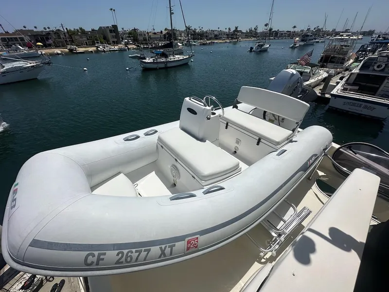 Slide: The Image of Inflatable boat docked near Azimut 55E yacht, 2006 model, in a marina setting. - 40