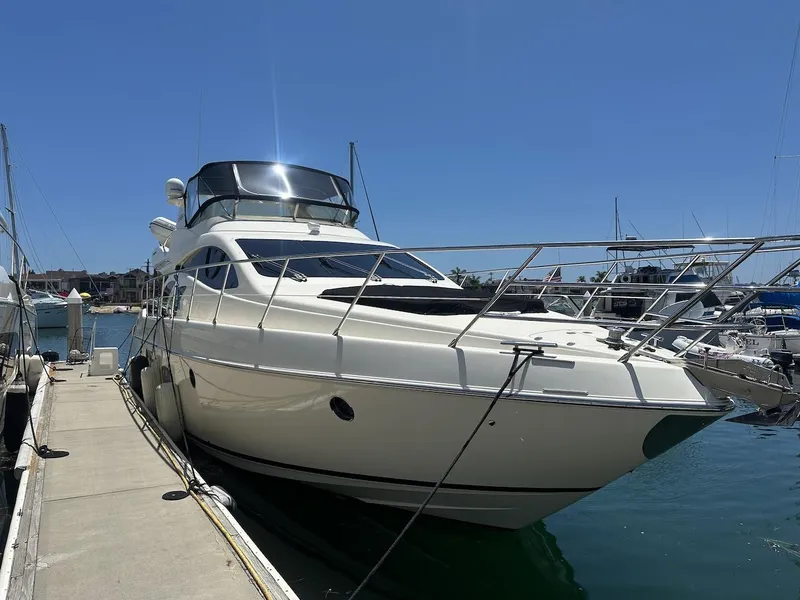 Slide: The Image of 2006 Azimut 55E yacht docked at marina under clear blue sky. - 45