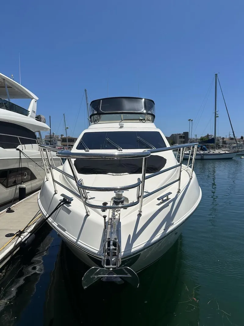 Slide: The Image of 2006 Azimut 55E yacht docked in a marina under clear blue sky. - 46