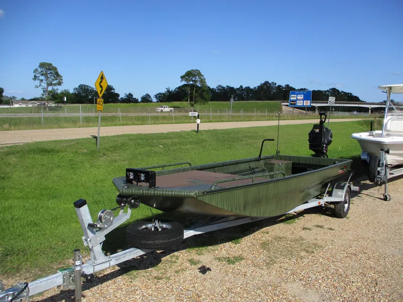 Slide: The Image of 2025 Gator Tail 2054 Extreme boat on trailer, parked roadside under clear blue sky. - 2