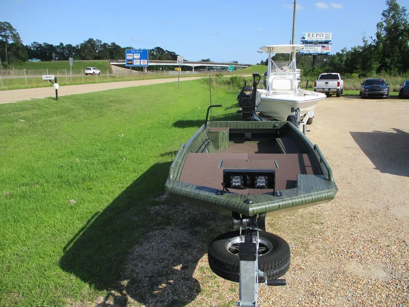 Slide: The Image of 2025 Gator Tail 2054 Extreme boat on trailer, parked on gravel near grassy roadside. - 3