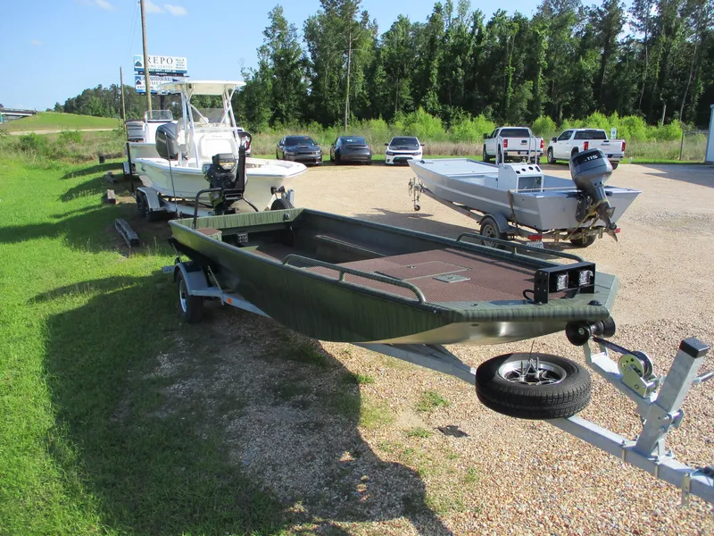 Slide: The Image of 2025 Gator Tail 2054 Extreme boat on trailer, parked with other boats and vehicles. - 4