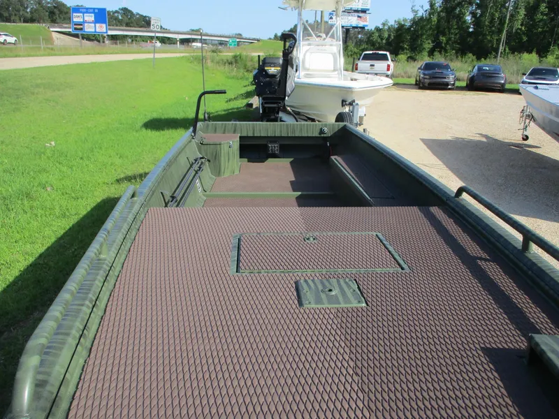 Slide: The Image of 2025 Gator Tail 2054 Extreme boat with spacious deck, parked near highway. - 6