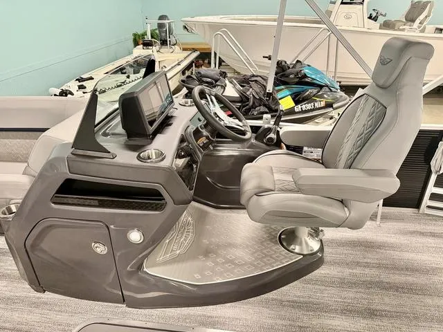 Slide: The Image of 2025 Bennington M Swingback 22 MSB boat helm with modern controls and comfortable captain's chair. - 10