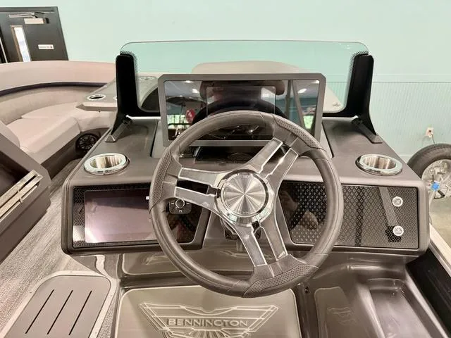 Slide: The Image of 2025 Bennington M Swingback 22 MSB boat dashboard with steering wheel and modern controls. - 11