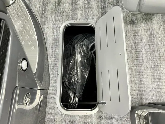 Slide: The Image of Open storage compartment on 2025 Bennington M Swingback 22 MSB boat, featuring sleek interior design. - 12