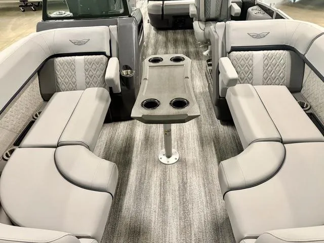 Slide: The Image of 2025 Bennington M Swingback 22 MSB interior with luxurious seating and central table. - 6