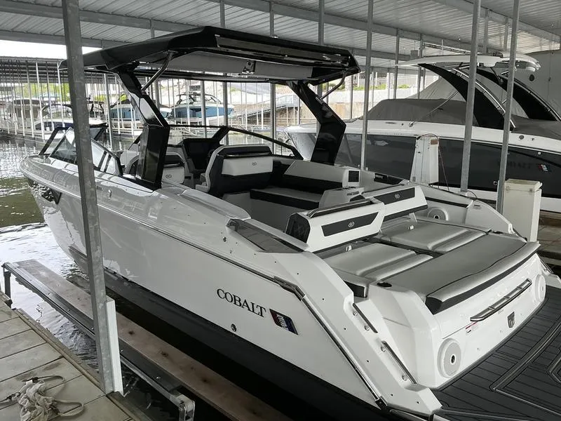 Slide: The Image of 2025 Cobalt R31 boat docked in a marina, featuring sleek design and modern amenities. - 1