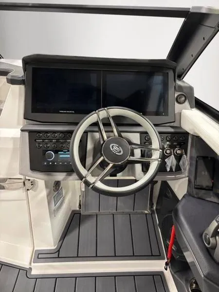 Slide: The Image of 2025 Cobalt R31 boat dashboard with modern steering wheel and control panel. - 15