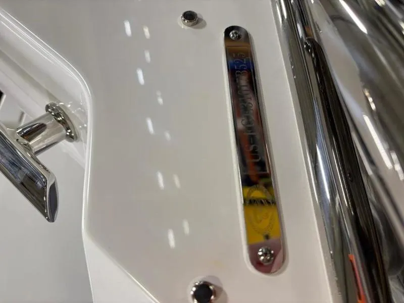 Slide: The Image of Close-up of 2025 Cobalt R31 boat detail with chrome and white finish. - 18