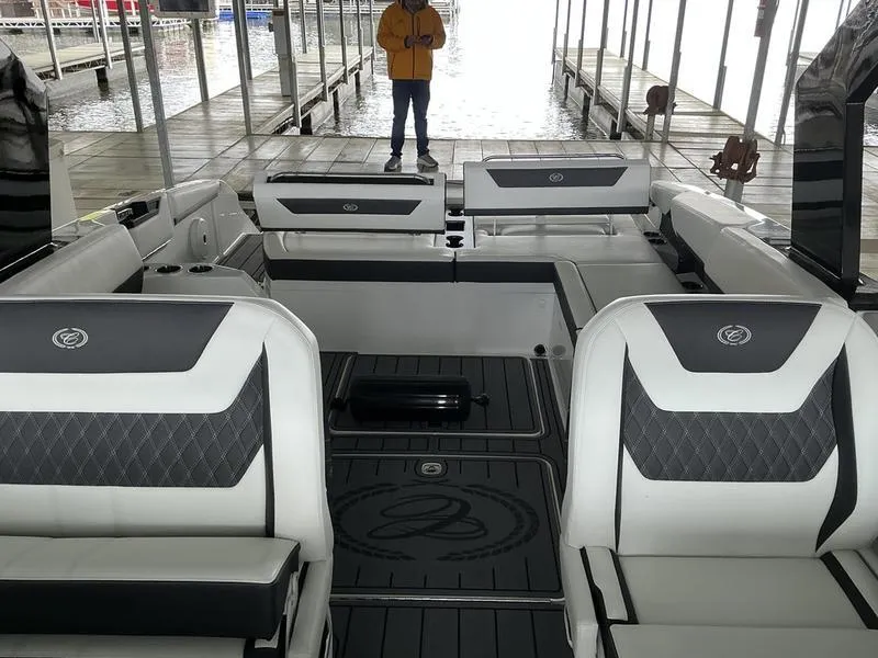 Slide: The Image of 2025 Cobalt R31 boat interior with luxurious seating and modern design at a dock. - 2