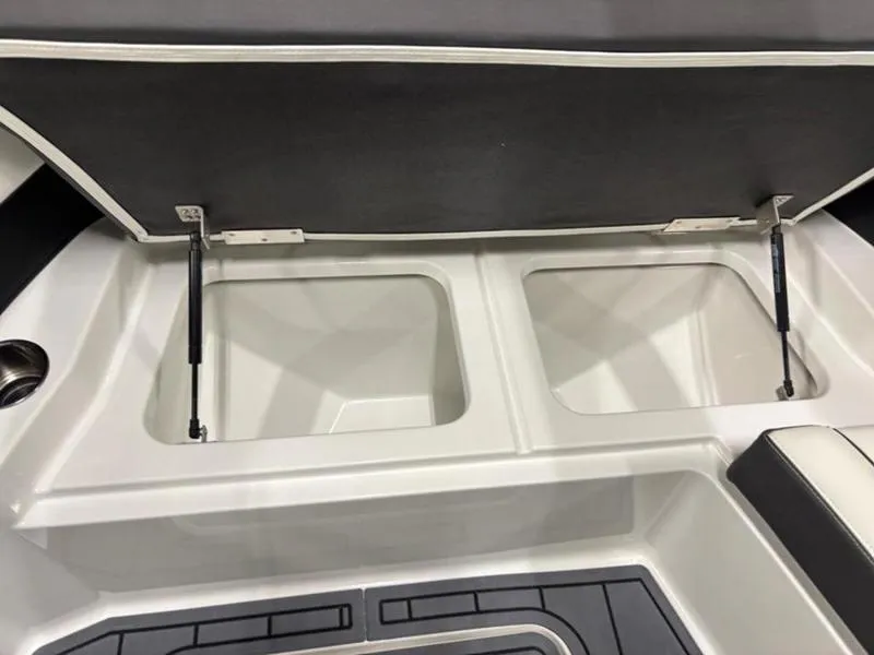 Slide: The Image of Open storage compartments in a 2025 Cobalt R31 boat interior. - 24