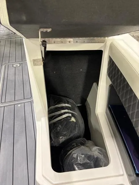 Slide: The Image of 2025 Cobalt R31 storage compartment with bags, featuring sleek interior design. - 25