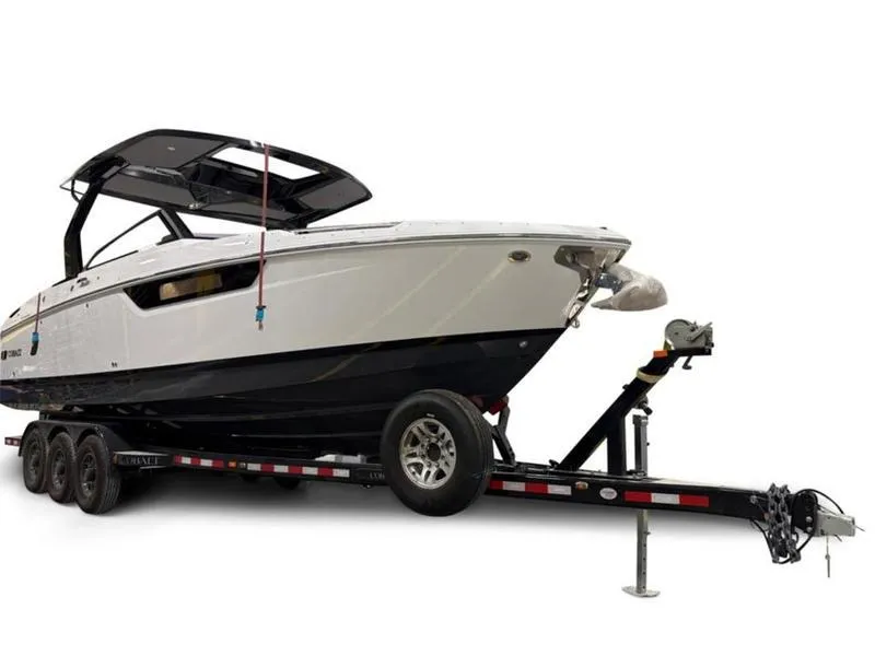Slide: The Image of 2025 Cobalt R31 boat on trailer, sleek design, black and white color scheme. - 3