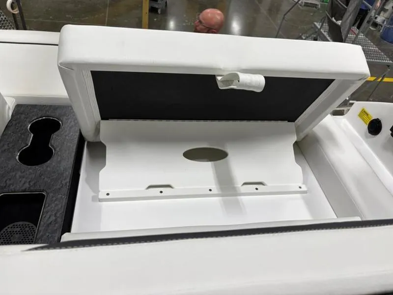 Slide: The Image of 2025 Cobalt R31 boat interior with storage compartment and cup holders. - 30
