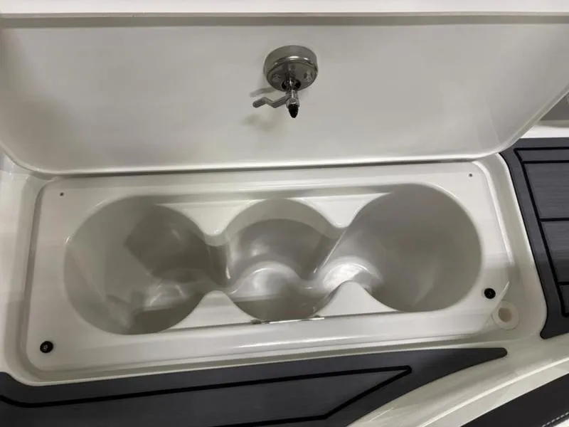 Slide: The Image of Storage compartment in 2025 Cobalt R31 boat, featuring a secure lock and sleek design. - 32