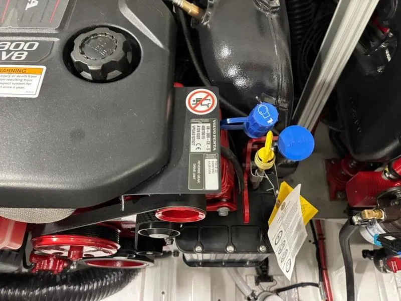 Slide: The Image of 2025 Cobalt R31 engine close-up, showcasing components and warning labels. - 40