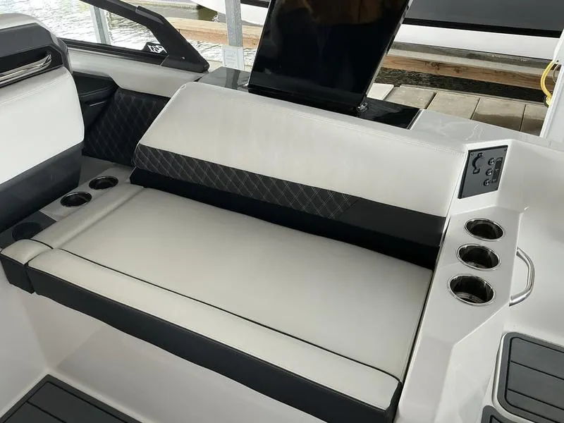 Slide: The Image of 2025 Cobalt R31 boat interior with cushioned seating and cup holders. - 43