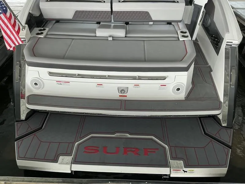 Slide: The Image of 2025 Cobalt R31 boat with "SURF" platform, gray seating, and American flag. - 45