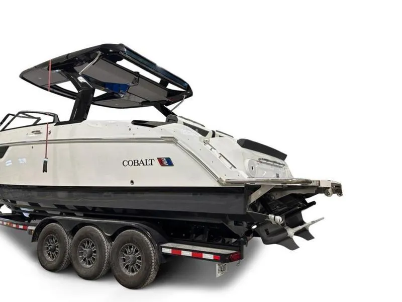 Slide: The Image of 2025 Cobalt R31 boat on trailer, rear view, white and black design. - 7