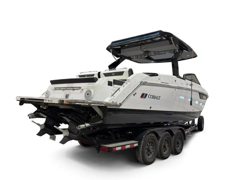 Slide: The Image of 2025 Cobalt R31 boat on trailer, rear view, showcasing sleek design and modern features. - 9