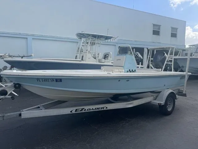 Slide: The Image of 2020 Hewes Redfisher 18 boat on EZ Loader trailer, parked outdoors. - 1