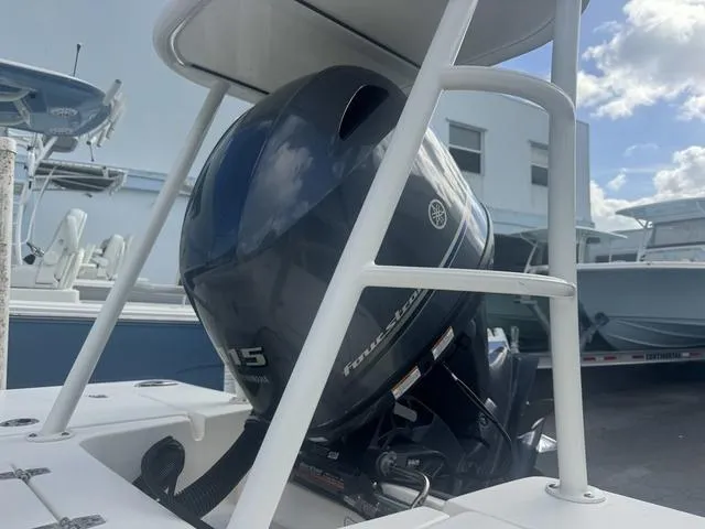 Slide: The Image of 2020 Hewes Redfisher 18 boat with Yamaha outboard motor, docked under clear skies. - 5