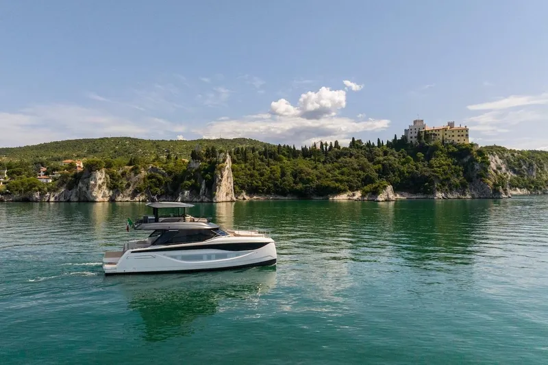 Slide: The Image of Luxury Prestige M7 yacht cruising near scenic coastline, 2025 model. - 27