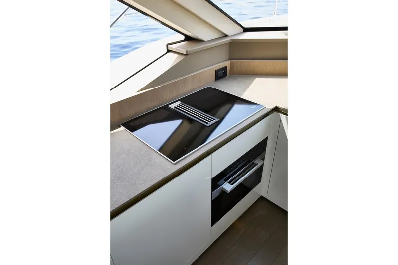 Slide: The Image of Modern kitchen area on Prestige M7 yacht, featuring sleek cooktop and oven, 2025 model. - 33