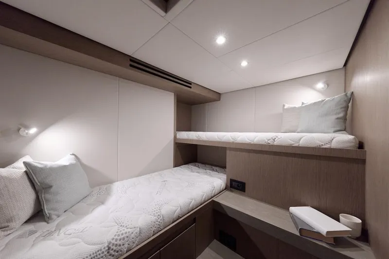 Slide: The Image of Luxurious 2025 Prestige M7 yacht cabin with modern bunk beds and soft lighting. - 47