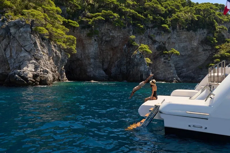 Slide: The Image of Luxury yacht Prestige M7, 2025 model, anchored near scenic rocky coastline. - 103