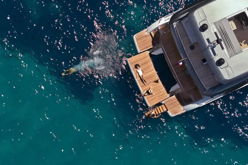 Slide: The Image of Aerial view of 2025 Prestige M7 yacht with people enjoying the ocean. - 107