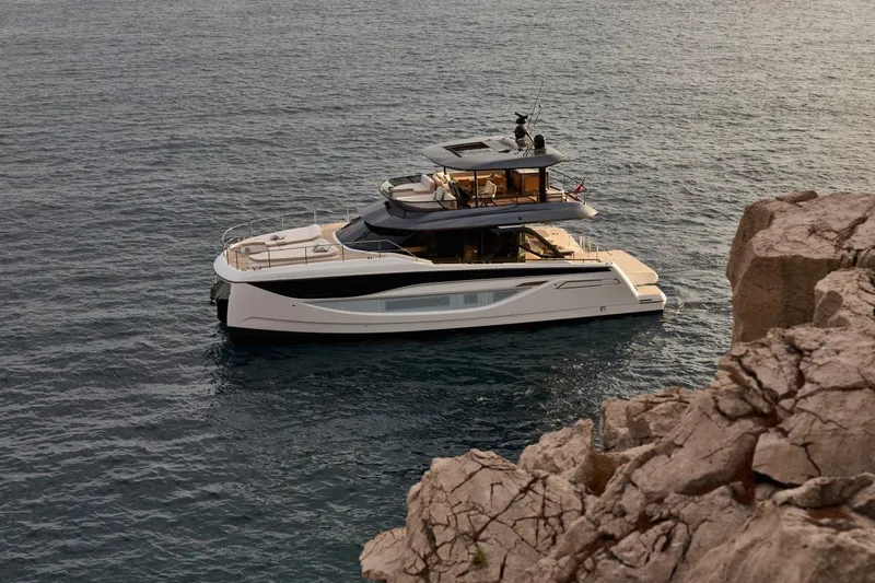 Slide: The Image of Luxury 2025 Prestige M7 yacht cruising near rocky coastline. - 113