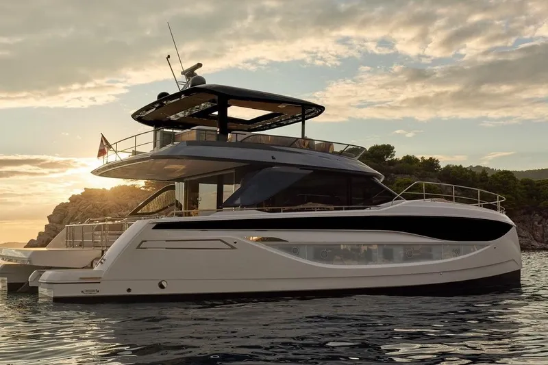 Slide: The Image of Luxury Prestige M7 yacht at sunset, 2025 model, cruising near rocky coastline. - 124