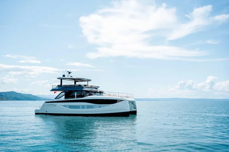 Slide: The Image of Luxury Prestige M7 yacht on serene blue waters, 2025 model. - 13