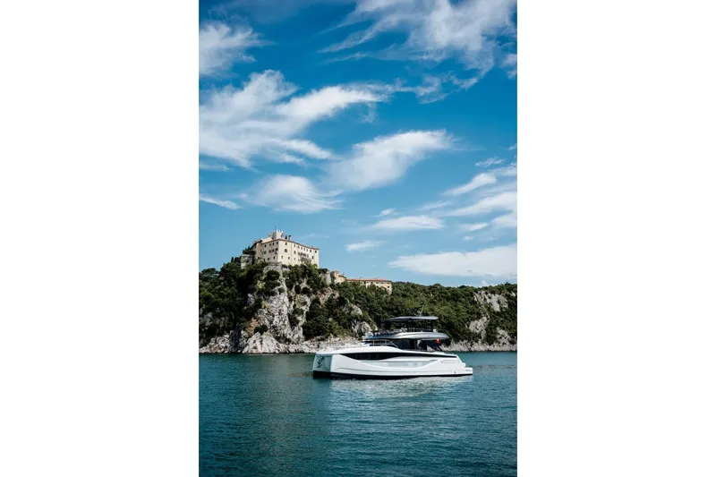 Slide: The Image of Luxury Prestige M7 yacht cruising near scenic coastal cliffs, 2025 model. - 19