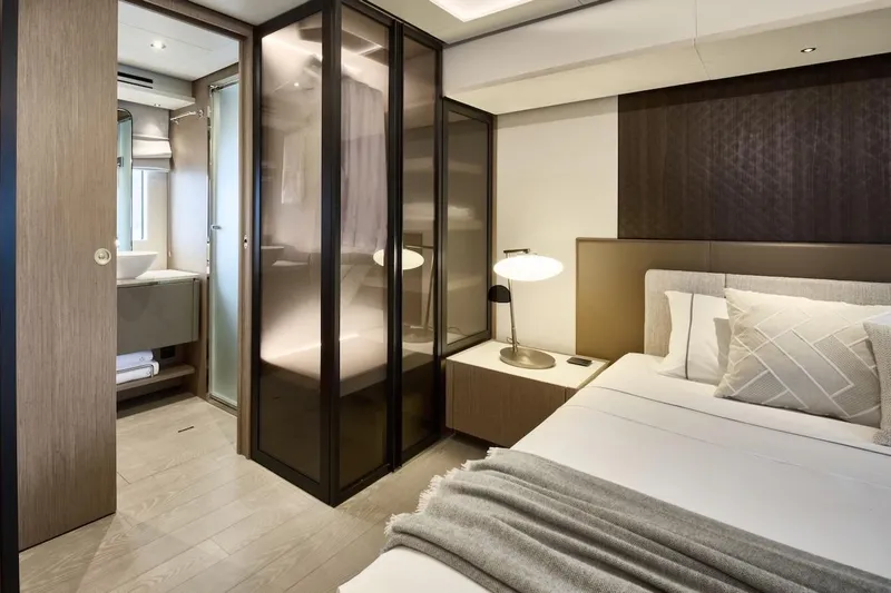 Slide: The Image of Luxurious Prestige M7 2025 yacht bedroom with modern design and ensuite bathroom. - 30
