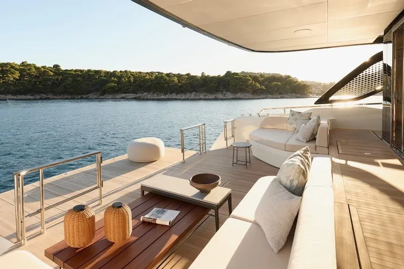 Slide: The Image of Luxurious Prestige M7 yacht deck with elegant seating, overlooking serene ocean and lush coastline. - 65