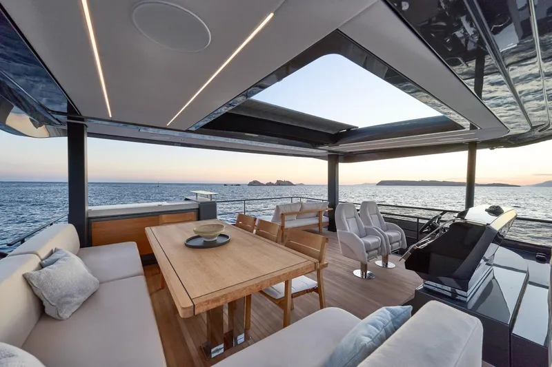 Slide: The Image of Luxurious Prestige M7 yacht interior with ocean view, featuring elegant seating and dining area, 2025 model. - 66