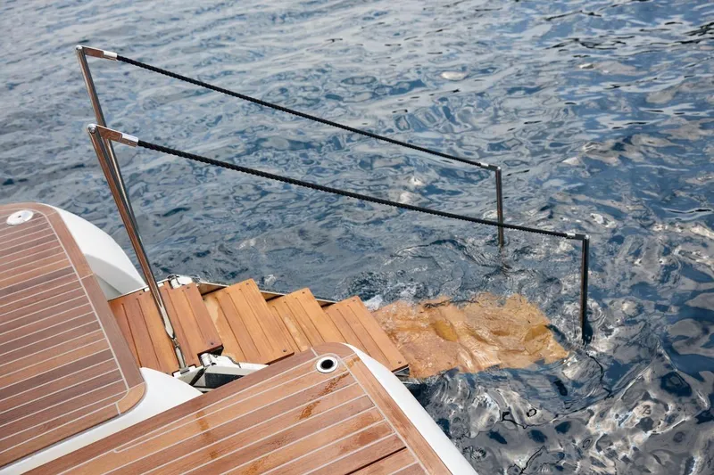 Slide: The Image of Luxury yacht Prestige M7 2025 with wooden swim platform and steps into water. - 79