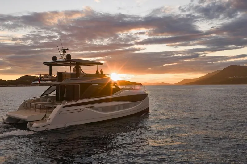 Slide: The Image of Luxury Prestige M7 yacht cruising at sunset, 2025 model, scenic ocean view. - 92