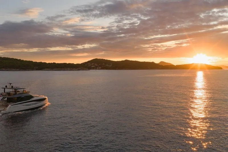 Slide: The Image of Luxury Prestige M7 yacht cruising at sunset, 2025 model, serene ocean view. - 93