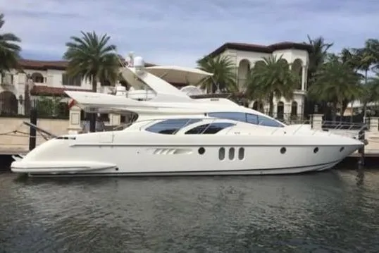 The Image of 2006 Azimut 62 yacht docked near luxury waterfront homes. - 0